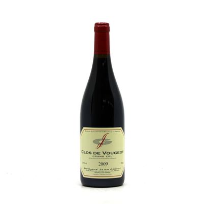 a bottle of red wine sitting on top of a white table