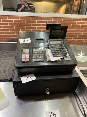 a cash register sitting on a counter in a restaurant