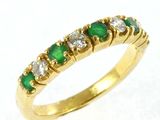 an image of a yellow gold ring with emerald and white diamonds