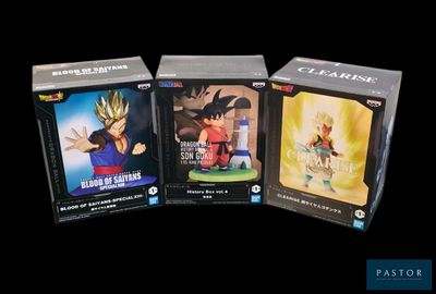 Trois boîtes de figurines Dragon Ball sont représentées sur un fond noir.