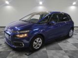 a blue citrole parked on a checkered floor in a garage