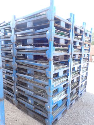 many pallets stacked on top of each other on the ground