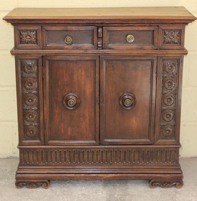 a wooden cabinet with two doors and two drawers