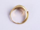 a close up of a gold ring on a white surface