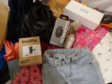 a pile of clothes and other items that are on a bed