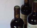 three bottles of wine that are sitting on a table
