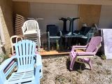 two lawn chairs and a table in the yard