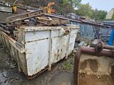 a dumpster that is sitting on the side of the road