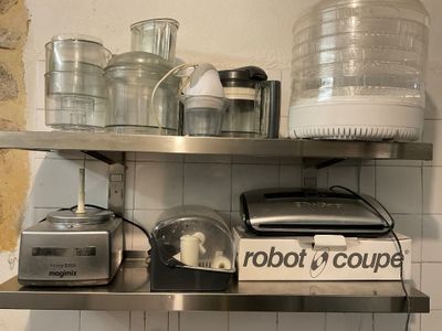 a metal shelf with a blender, a blender, and a blender on it