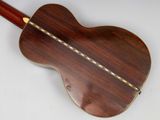 a close up of a wooden guitar with a white background