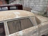 an old car that has been rusted and is parked in a garage