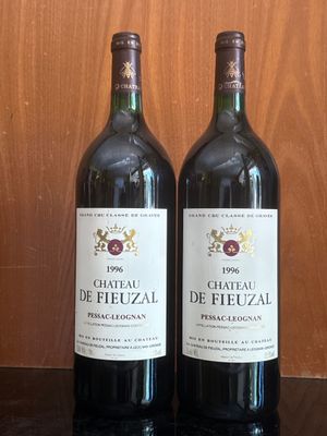 two bottles of wine that are sitting on a table