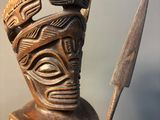 statue of a man holding a spear and shield in his hand