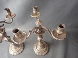a silver candelab with three candles on it