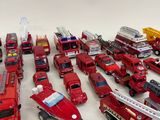 a lot of toy fire trucks that are on the table