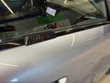 a car that has a sticker on it ' s side window