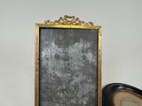 a picture of a mirror and a clock on a table