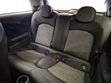 two seats in the back of a car with a red button