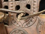 a close up of a wooden chair with carvings on it