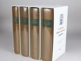three books in a white box on a table with a gray background
