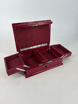 a red box with two compartments on a white surface