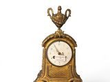 a gold clock with a crown on top of it