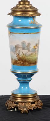 a blue vase with a painting on it sitting on a table