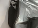 the back of a backpack that is open and sitting on a bed
