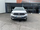 a white volkswagen suv parked in front of a building