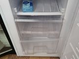 a small refrigerator with a lot of food inside of it