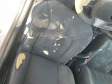 a dirty seat in a car with a dirty seat cover