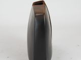 a black vase with a wooden handle on a white surface