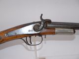 an old gun with a wooden handle on display in a museum