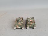 two toy tanks that are sitting on a table