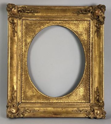 a gold picture frame with a white background and a white wall