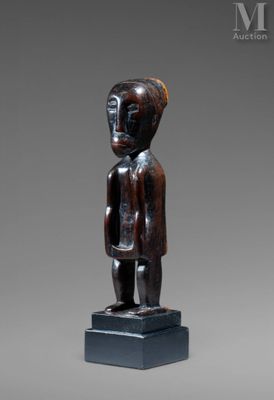 a wooden statue of a man standing on a pedestal