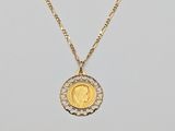 a gold coin necklace with a small diamond disc on a gold chain