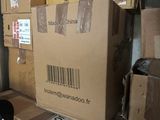 many boxes stacked on top of each other in a room