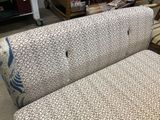 a couch that is sitting in a room with a lot of furniture
