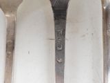 three spoons that are sitting next to each other on a table
