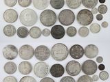 a collection of silver and silver coins from around the world