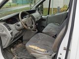 the interior of a white van with the door open and the driver ' s seat down