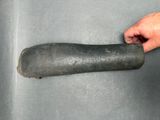 a person holding a large object in a metal container