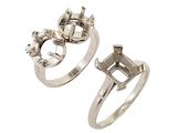 two silver rings with diamonds on them on a white background