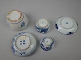 several pieces of blue and white porcelain are arranged on a table