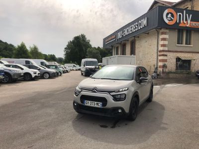 the car is parked in front of a building with many cars parked in front of it