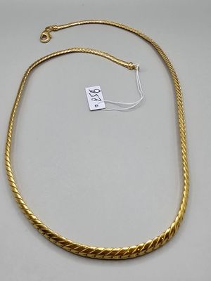 a gold rope necklace with a tag on it