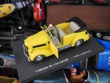 a yellow toy car sitting on top of a black table
