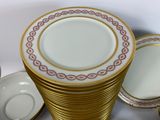 a stack of plates and cups sitting on a table