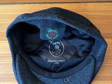 grey wool cap with a black label on the front of it